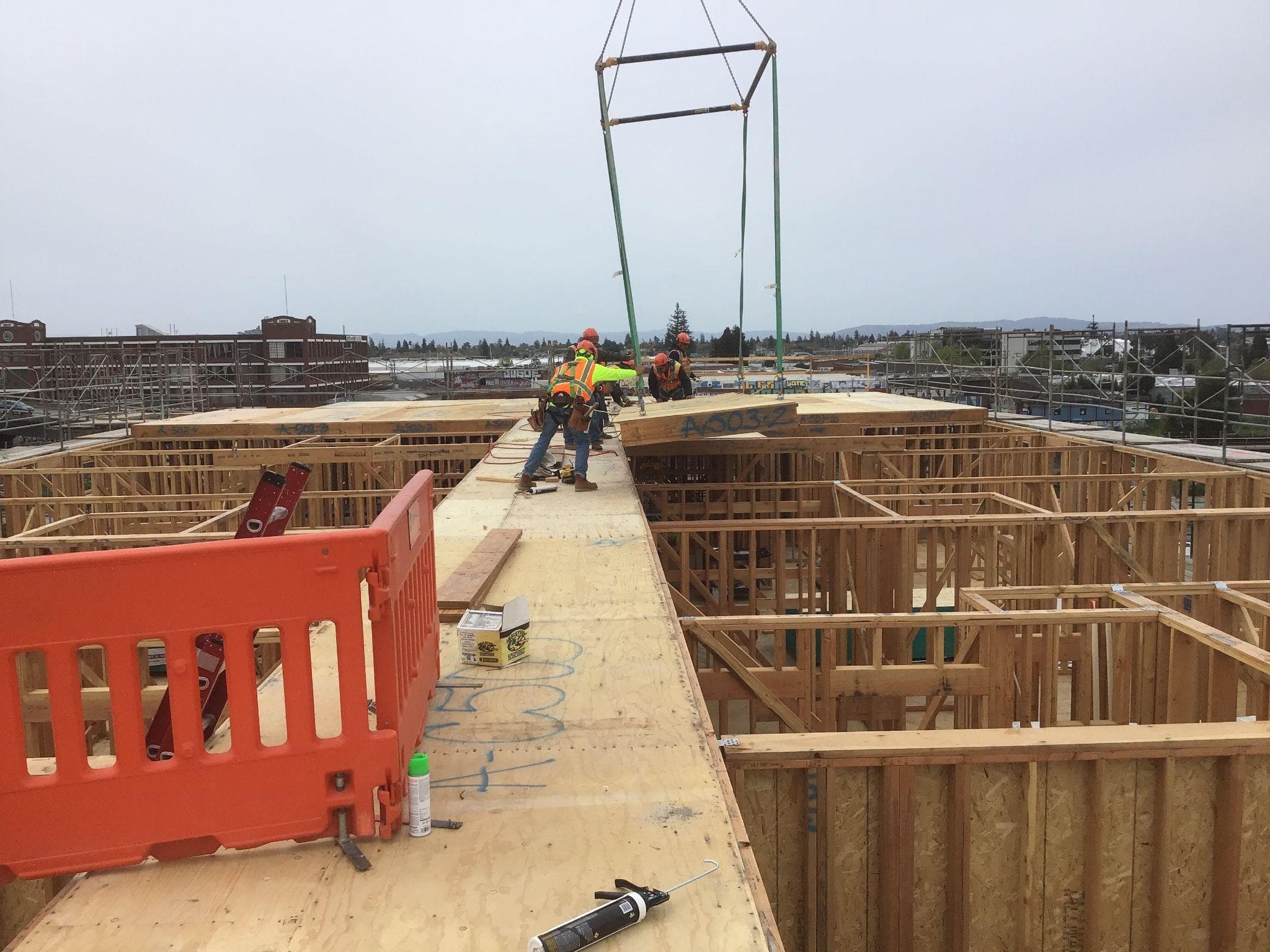 Crew installing panels on elevated deck