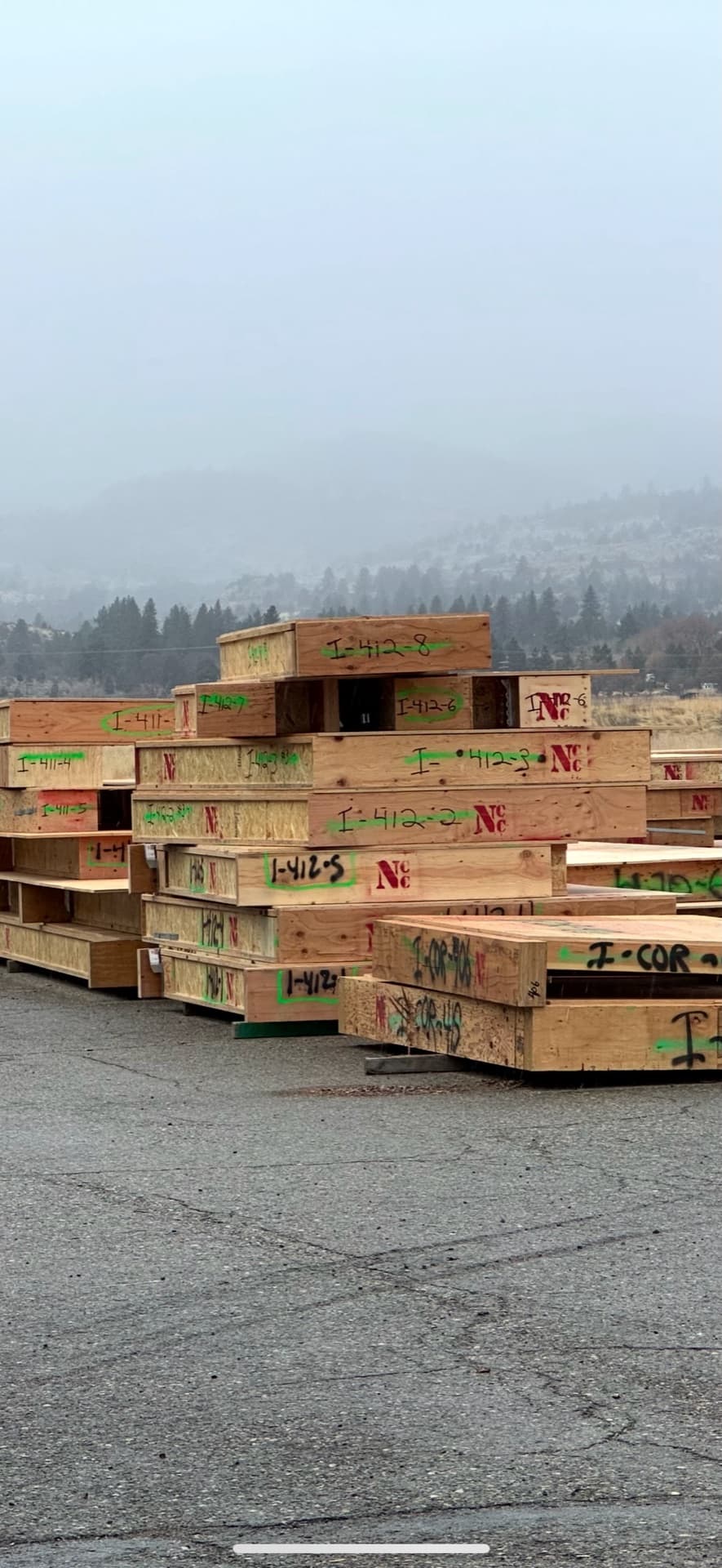 Stacked cassettes in yard with foggy mountains