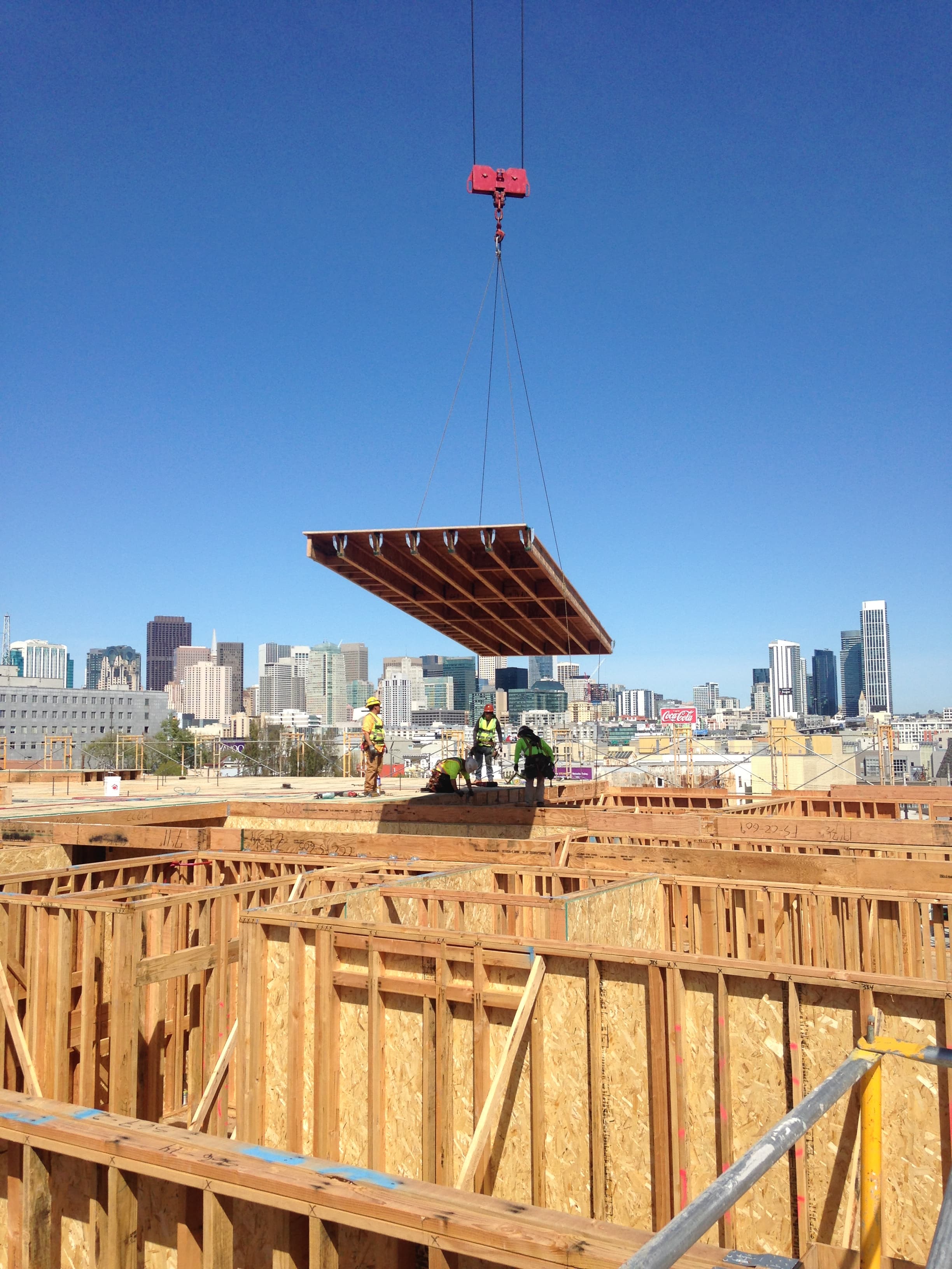 NCC crane lifting floor cassette with city skyline