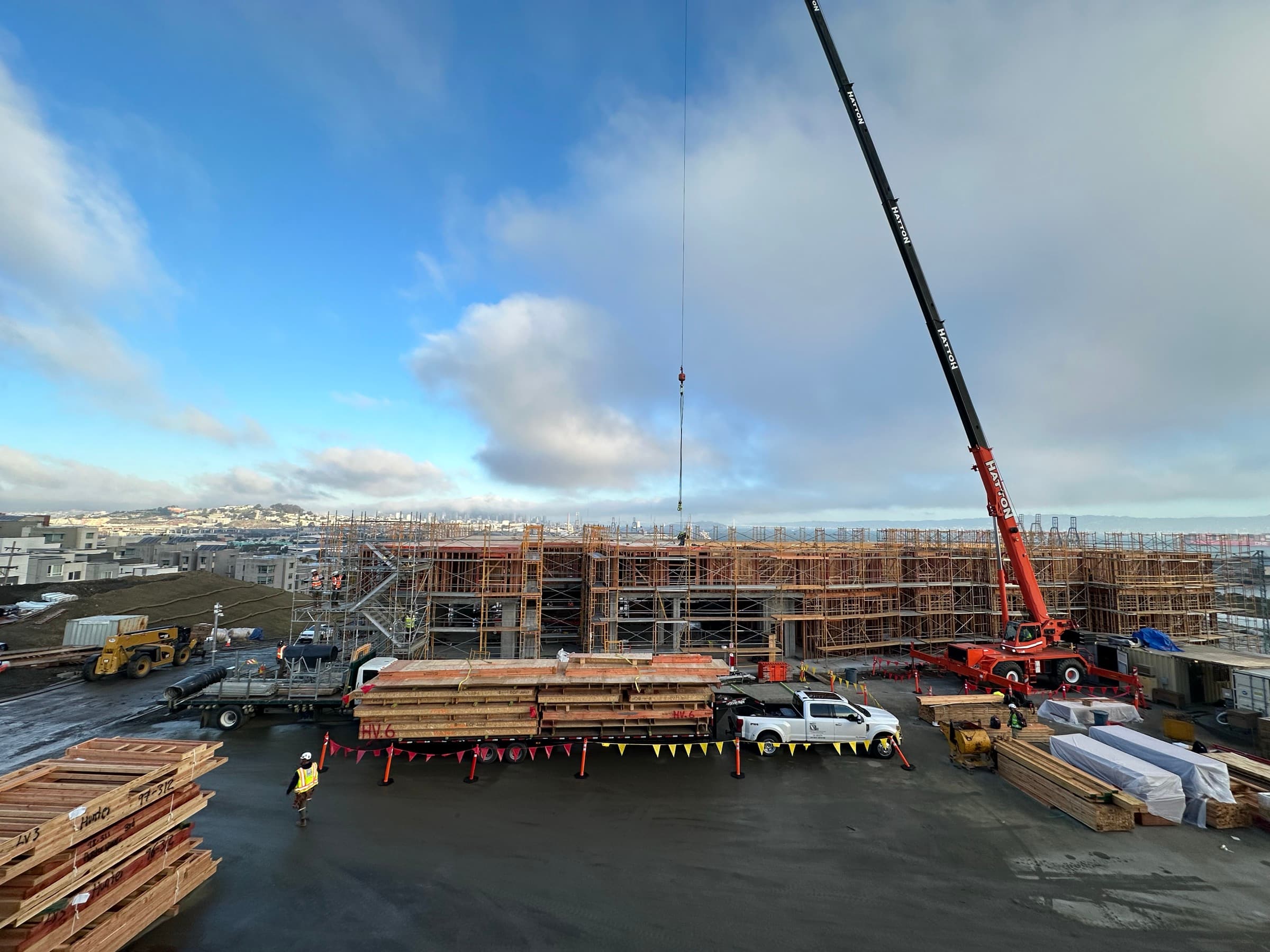 Hunters View construction site with crane and stacked panels