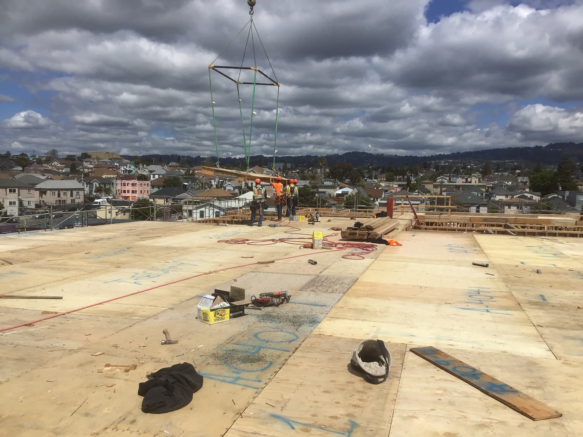Workers on completed deck with dramatic sky behind
