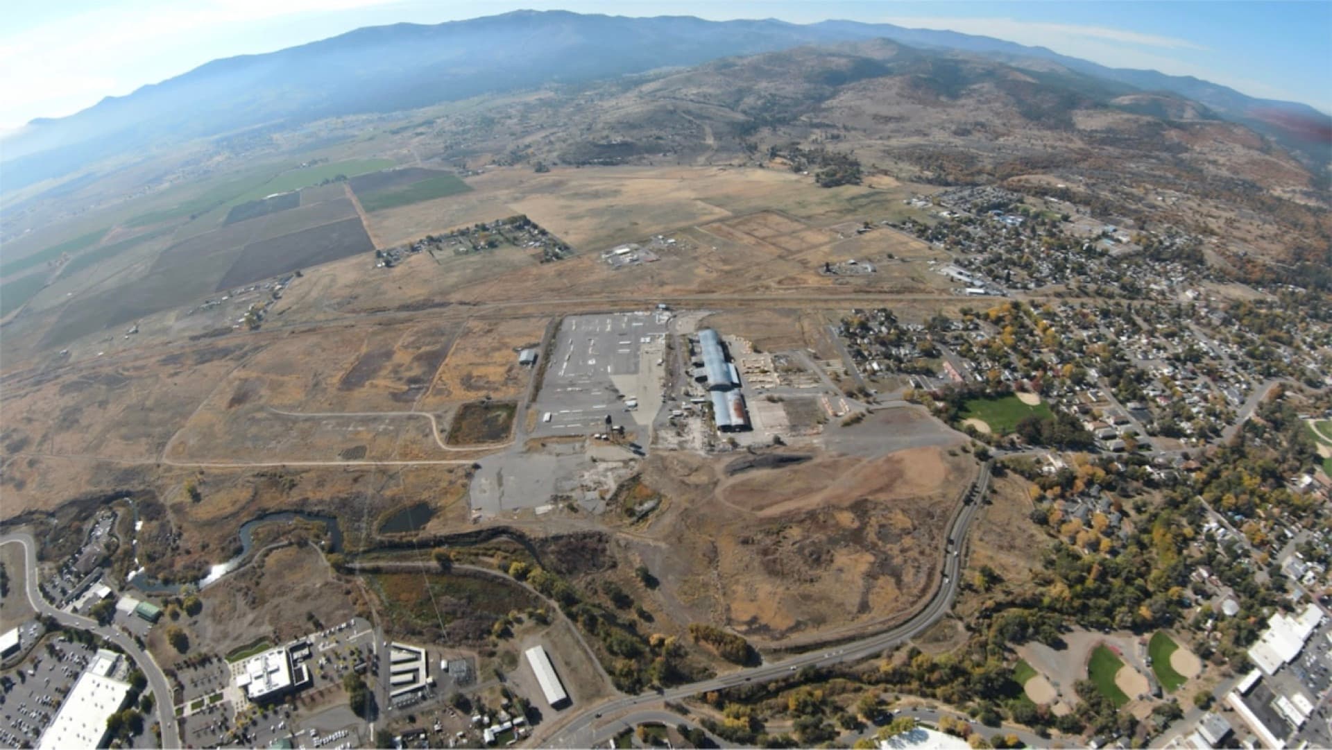 Aerial view of NCC headquarters and fabrication campus in Susanville, California with mountains in background
